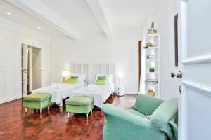sala de estar con 2 sofás blancos y sillas verdes en Residenza Torre Vecchiarelli - apt 4, en Roma