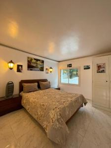 a bedroom with a large bed and a window at Dar Riahi Ras Jbal in Raʼs al Jabal