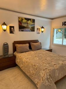 a bedroom with a bed and a tv and a window at Dar Riahi Ras Jbal in Raʼs al Jabal