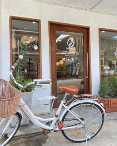 a white bike parked outside of a store at Le Moon Hotel in Chiang Khan