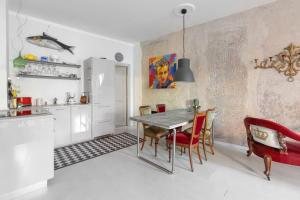 a kitchen and dining room with a table and chairs at Casa Elena Lago - Maggiore Estate by Ginin in Cannobio +8 photos
