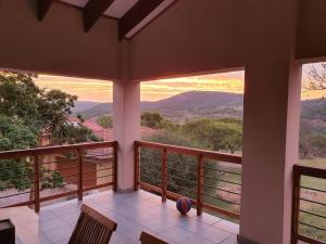 a balcony with a view of the mountains at Wild Fig Wild Life Estate White River in White River