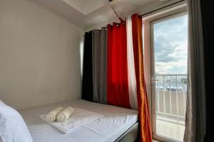 a room with a bed with a window with a view at Condo Suite Near NAIA 3 and Mall of Asia in Manila