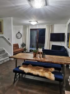 a living room with a wooden table and a couch at Riverside Cockatoo's Cottage Charming 3 Bed Retreat for up to 10 Guests in Stockton-on-Tees