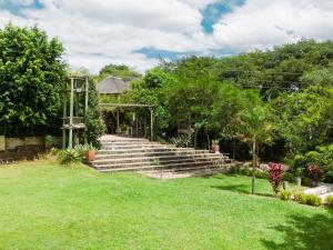 a set of stairs in a yard with trees at Mihandzu Guest House in Hazyview