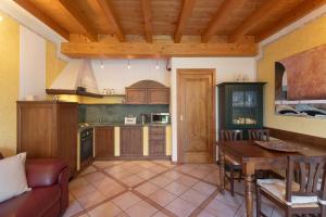 a kitchen with a table and a dining room at Residence Garda Sole 3-69 by Wonderful Italy in Padenghe sul Garda