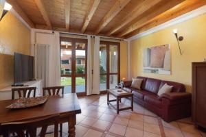 a living room with a couch and a table at Residence Garda Sole 3-69 by Wonderful Italy in Padenghe sul Garda