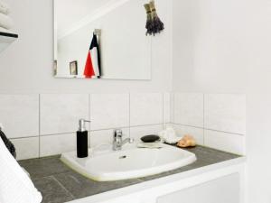 a white bathroom with a sink and a mirror at 5 person holiday home in LYSEKIL in Lysekil +20 photos