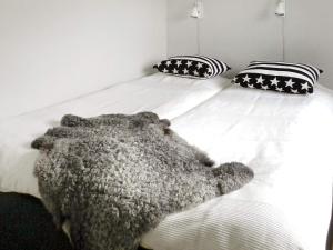 a bedroom with a bed with a teddy bear on it at Holiday Home Sörkila in Lysekil