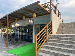 um restaurante com escadas e um tapete verde em frente em Hotel Eco Park Rewa em Rewa