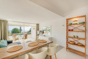 a kitchen and dining room with a table and chairs at Secret View Riviera Miraflores in La Cala de Mijas