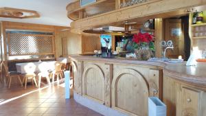 a kitchen with a counter and a dining room at Hotel Cielo Blu in Passo del Tonale