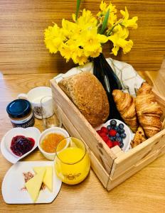 a wooden table with a basket of food and flowers at Luxury Stargazing Glamping - Seren Aur in Llanidloes