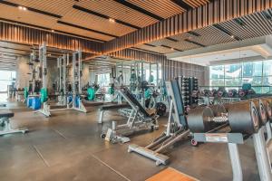 a gym with lots of equipment in a room at Veloura by Kozystay - Setiabudi in Jakarta