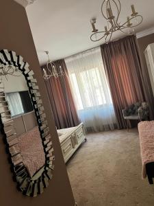 a bedroom with a mirror and a bed and a chair at Pensiunea Baroc in Braşov