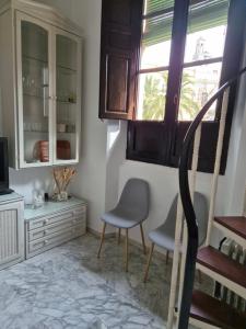 een eetkamer met 2 stoelen en een raam bij Catedral Suite in Granada