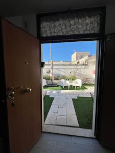 an open door to a patio with a table and chairs at Truly Apulia in Bari