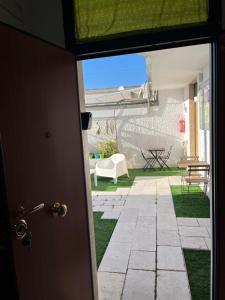 an open door with a view of a yard at Truly Apulia in Bari