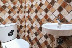 a bathroom with a toilet and a sink at RedDoorz Syariah near Telanaipura Jambi in Jambi