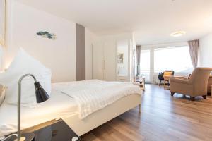a hotel room with a bed and a chair at Lord Nelson 715 in Döse +17 photos