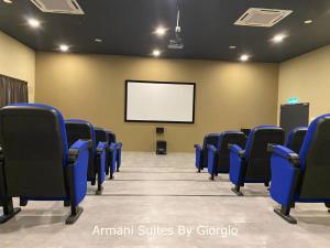 an empty room with blue chairs and a screen at Subang Jaya Armani Soho in Subang Jaya +115 photos