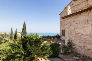 a brick building with a palm tree next to it at Villa Cri Cri B&B di Charme in San Benedetto del Tronto