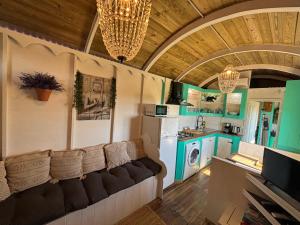 a living room with a couch and a kitchen at Vintage chalet with stunning vieuws in Estepona