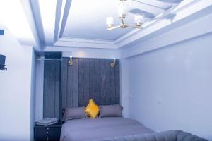a bedroom with a bed and a chandelier at Superb High spec Studios . Kabete. 15 Mins from Westlands in Nairobi