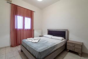 a bedroom with a large bed and a window at King home Larissa city in Larisa