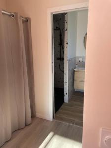 an open door to a bathroom with a sink at Maison au cœur des Pyrénées ! in Ayzac-Ost