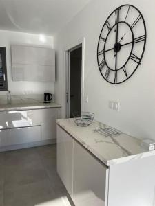 a kitchen with a large clock on the wall at Maison au cœur des Pyrénées ! in Ayzac-Ost