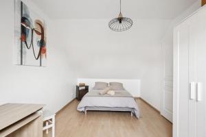 1 dormitorio con 1 cama en una habitación blanca en Kandinsky - 3 chambres à Roissy, en Le Thillay