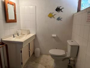 a bathroom with a toilet and a sink at Paradise Dunes in Praia do Tofo