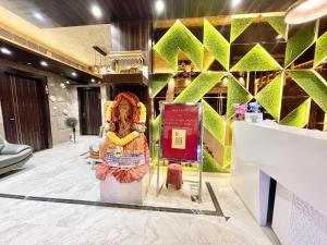 a store with a large statue in a lobby at Hotel KP ! Puri near-sea-beach-and-temple fully-air-conditioned-hotel with-lift-and-parking-facility in Puri