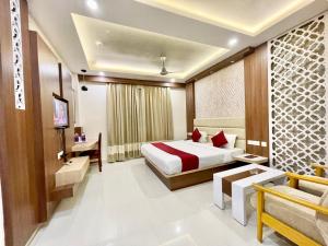 um quarto de hotel com uma cama e uma televisão em Hotel KP ! Puri near-sea-beach-and-temple fully-air-conditioned-hotel with-lift-and-parking-facility em Puri