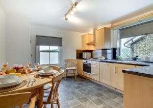 a kitchen with a table and a dining room at Happy Valley in Cromer