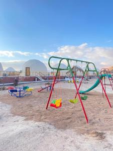 a group of playground equipment on a sandy beach at Bilal luxury camp in Wadi Rum