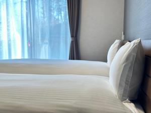 Postel nebo postele na pokoji v ubytování 72 Mt View - B棟 -