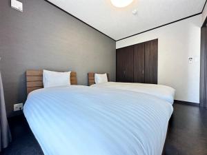 Postel nebo postele na pokoji v ubytování 72 Mt View - B棟 -