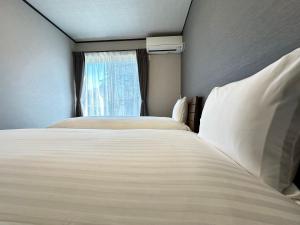 Postel nebo postele na pokoji v ubytování 72 Mt View - B棟 -