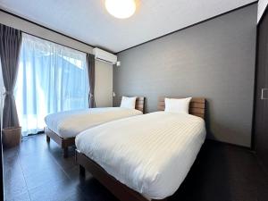 Postel nebo postele na pokoji v ubytování 72 Mt View - B棟 -