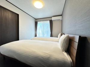 Postel nebo postele na pokoji v ubytování 72 Mt View - B棟 -