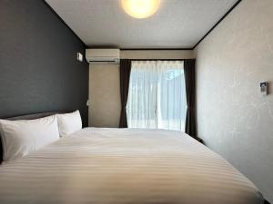 Postel nebo postele na pokoji v ubytování 72 Mt View - B棟 -