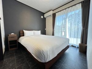 Postel nebo postele na pokoji v ubytování 72 Mt View - B棟 -