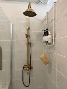 a bathroom with a shower with a shower head at Le grand Louis, hypercentre in Cherbourg en Cotentin