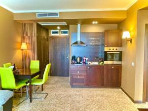 a kitchen and dining room with a table and yellow chairs at Z-apartment in Sunny Beach