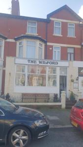 a black car parked in front of a white window at THE WILFORD HOTEL in Blackpool