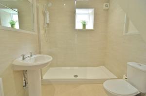 a bathroom with a sink and a tub and a toilet at Trade Digs Ryeleaze Road in Stroud
