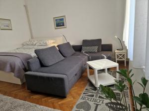 a living room with a couch and a bed at "Apartment Lavanda Idila", speed WiFi in Zagreb