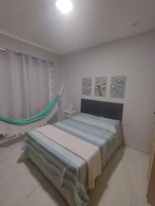 Un dormitorio con una cama y una hamaca. en Lar das Cerejeiras en Bananeiras